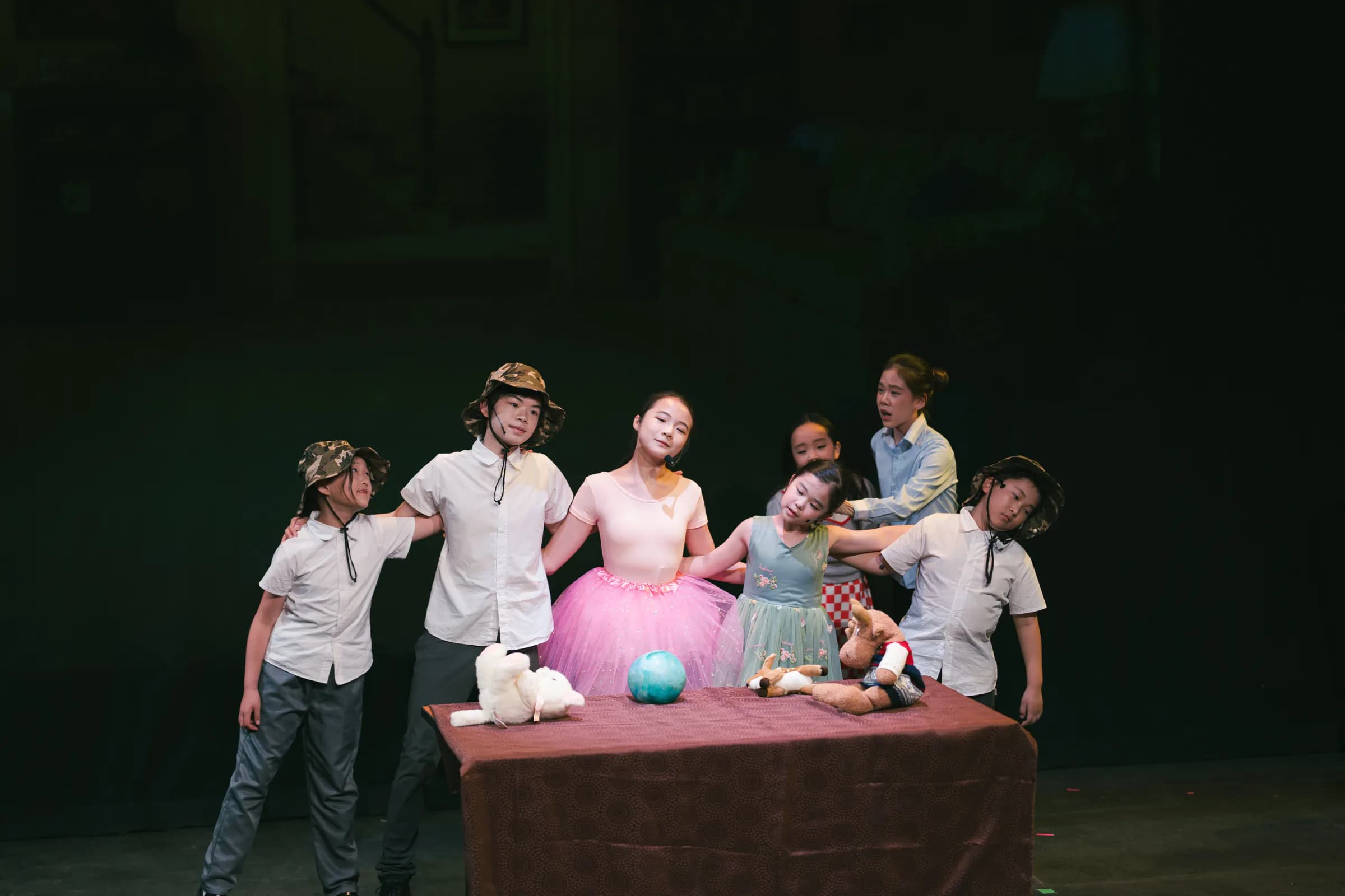 Young TADA performers acting together in a staged birthday-party scene.