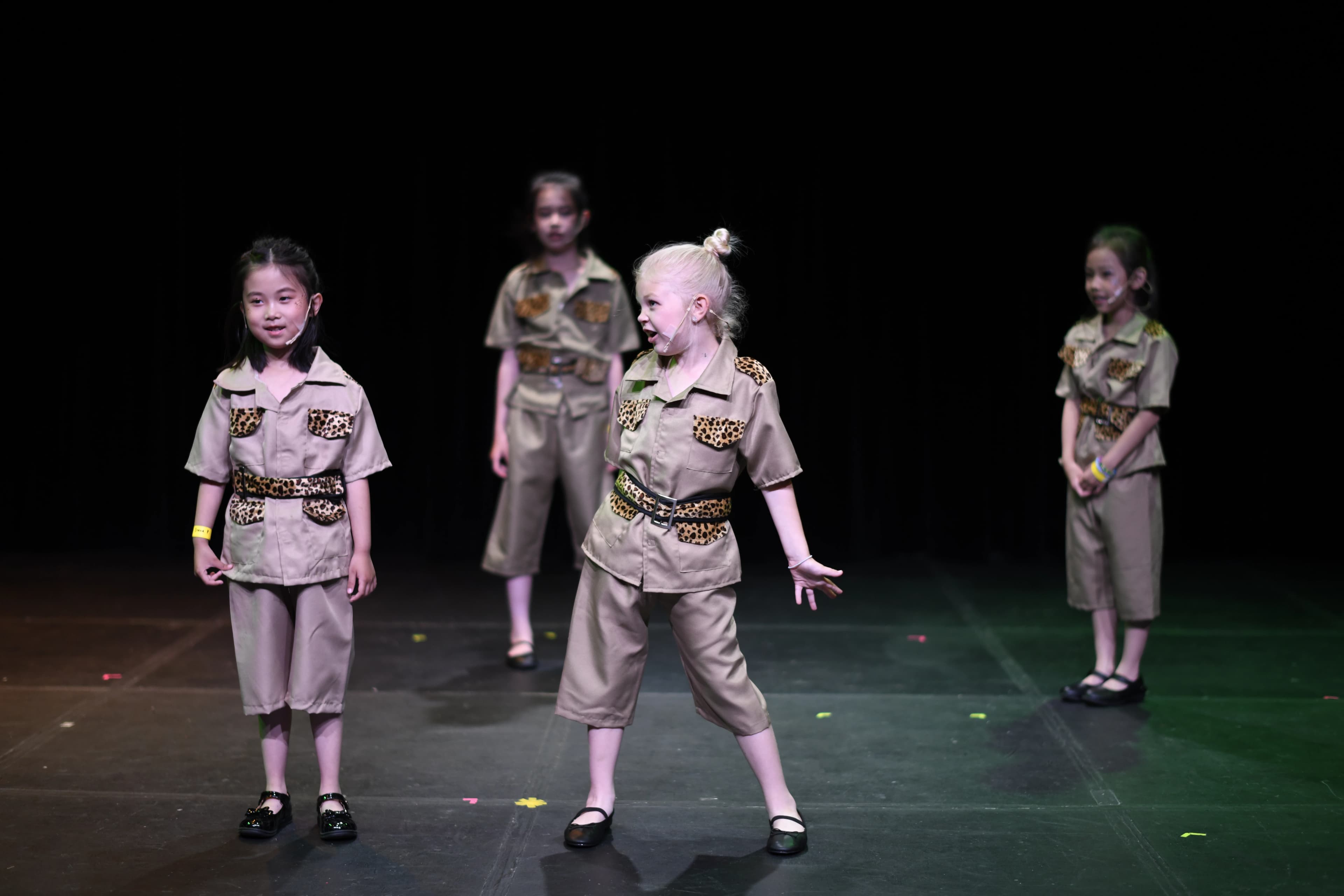 TADA students dancing onstage in safari costumes