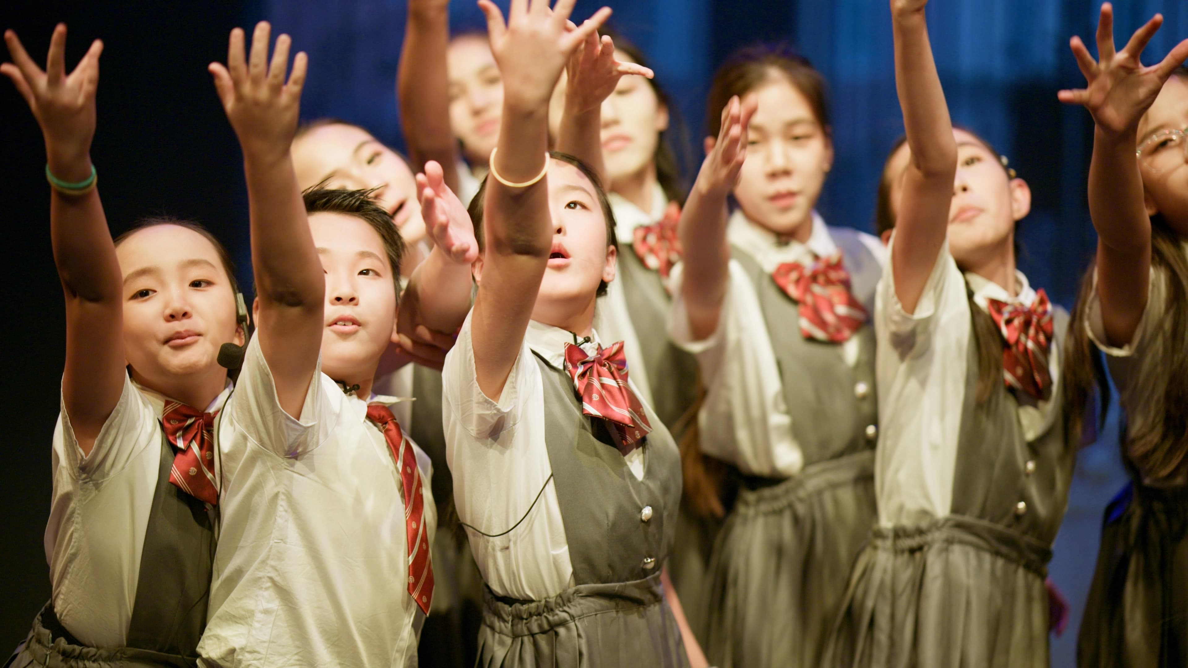 TADA students reaching their hands together