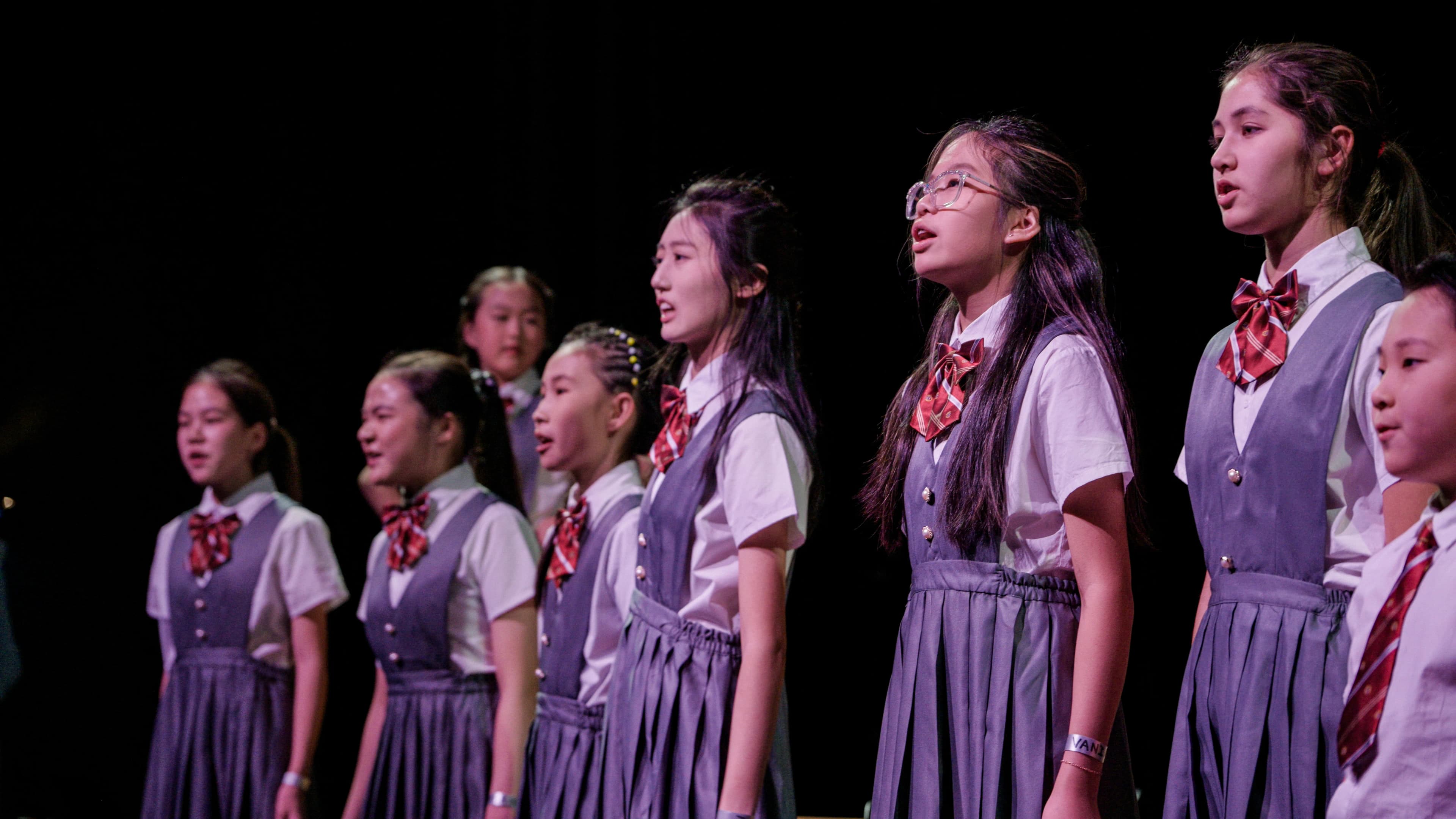 Young TADA performers on stage in a line.