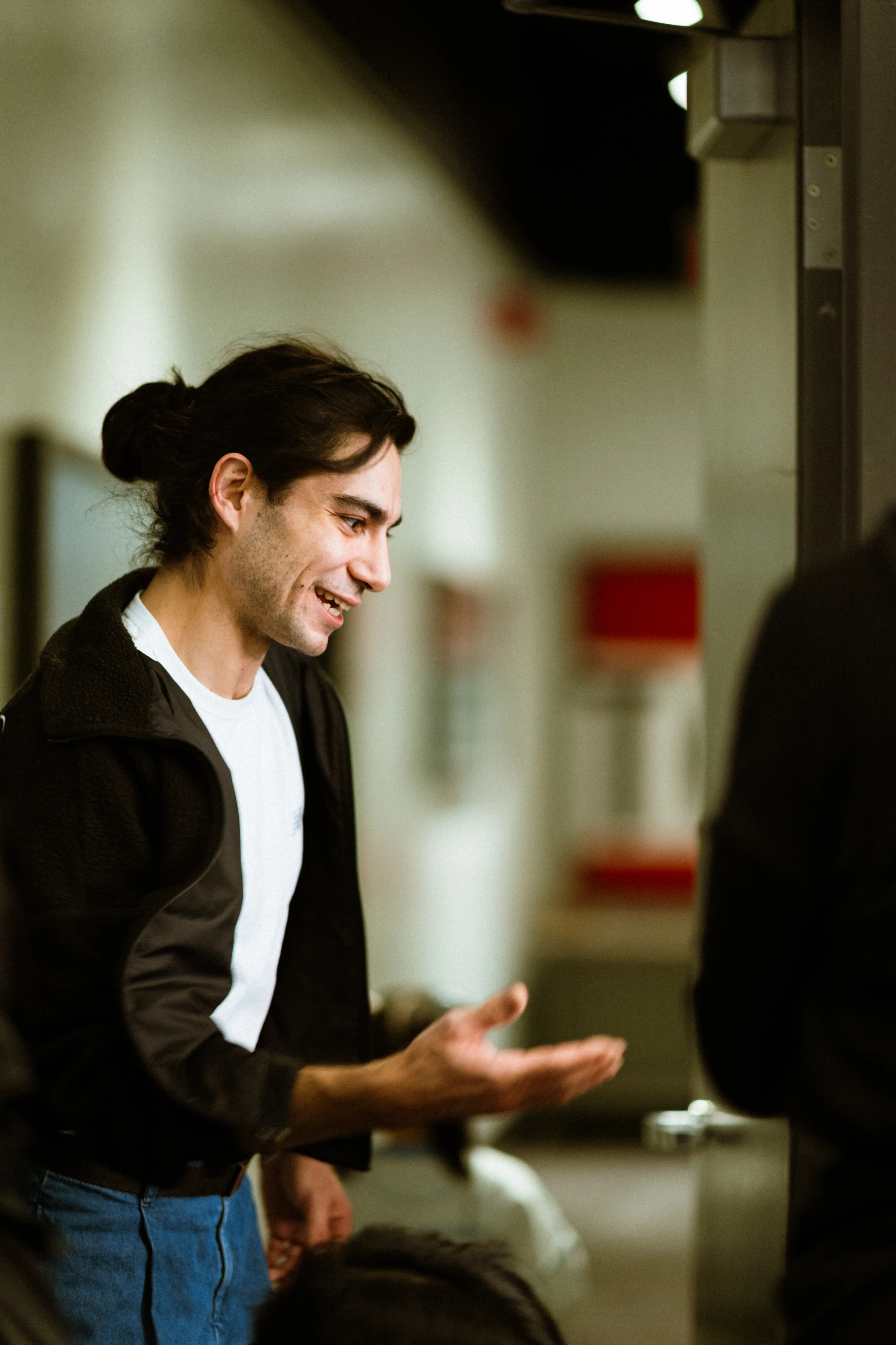A TADA dance teacher, gesturing and explaining a move with his hands.